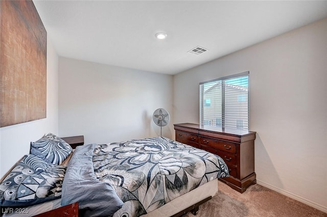 bedroom with light carpet, visible vents, and baseboards