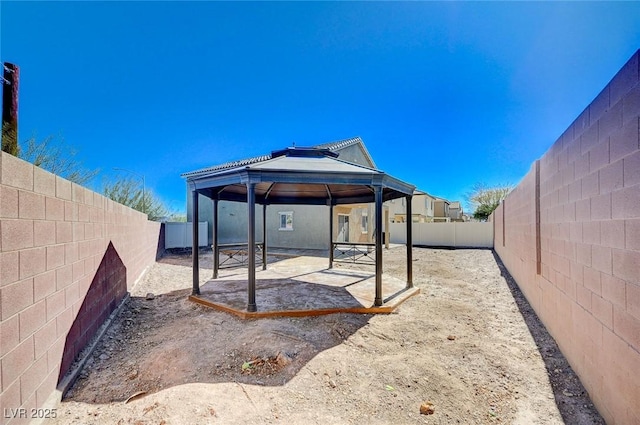 view of yard with a patio area, a fenced backyard, and a gazebo