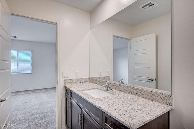 bathroom featuring baseboards, visible vents, and vanity