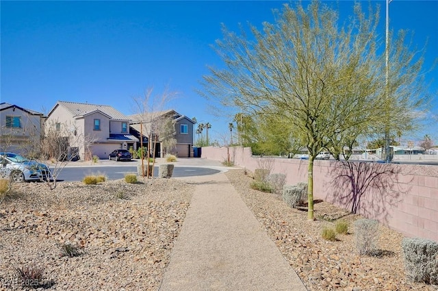 view of yard with a residential view and fence