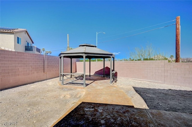 view of yard featuring a fenced backyard and a gazebo