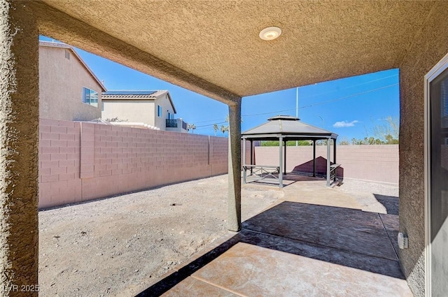 view of patio featuring a fenced backyard and a gazebo