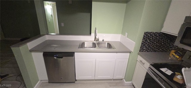 kitchen featuring sink, white cabinets, and stainless steel appliances