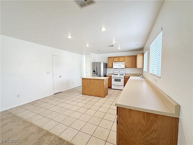 11036 Parete Ct, Las Vegas, NV 89141 - kitchen featuring white appliances, light countertops, a kitchen island, light tile patterned floors, and recessed lighting