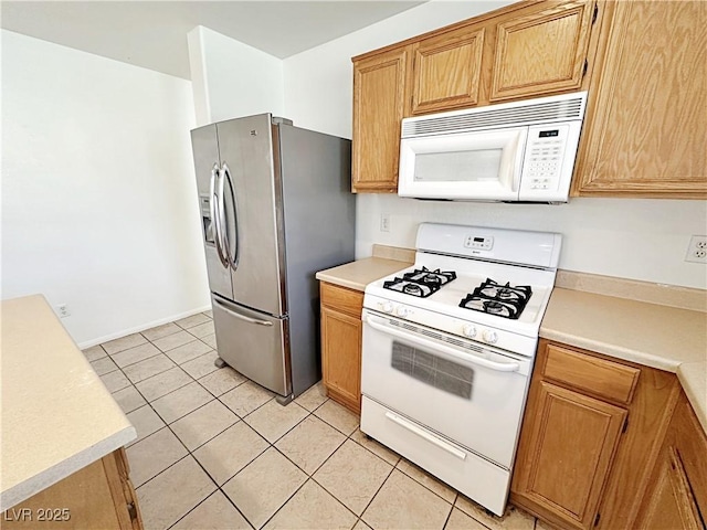 11036 Parete Ct, Las Vegas, NV 89141 - kitchen with white appliances, light countertops, and light tile patterned flooring