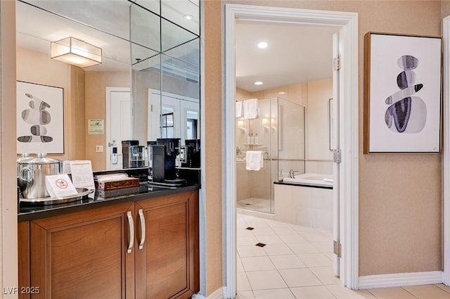 bathroom with tile patterned floors, separate shower and tub, and vanity