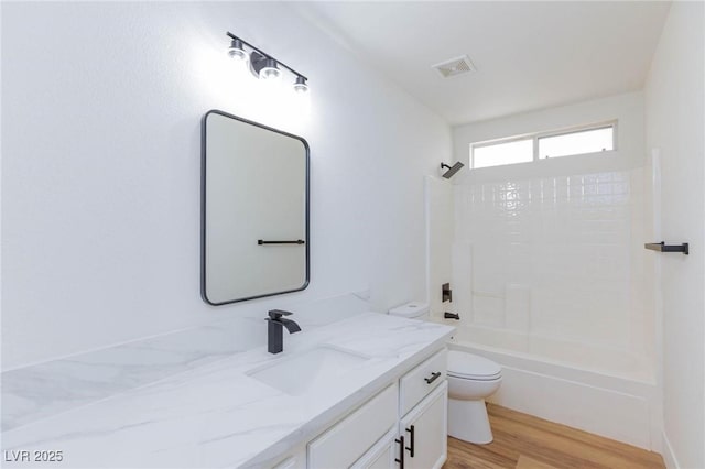 full bathroom featuring vanity, bathtub / shower combination, hardwood / wood-style floors, and toilet