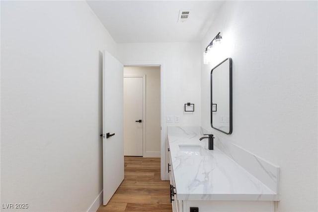 bathroom with vanity and hardwood / wood-style floors