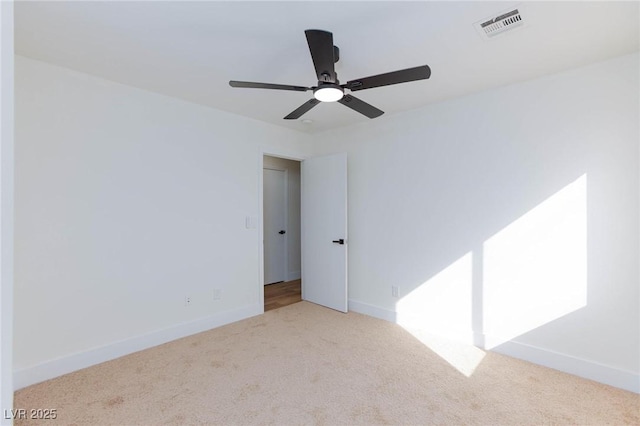 carpeted spare room with ceiling fan