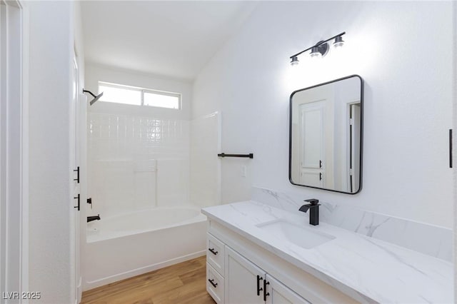 bathroom featuring vanity, hardwood / wood-style flooring, and bathtub / shower combination