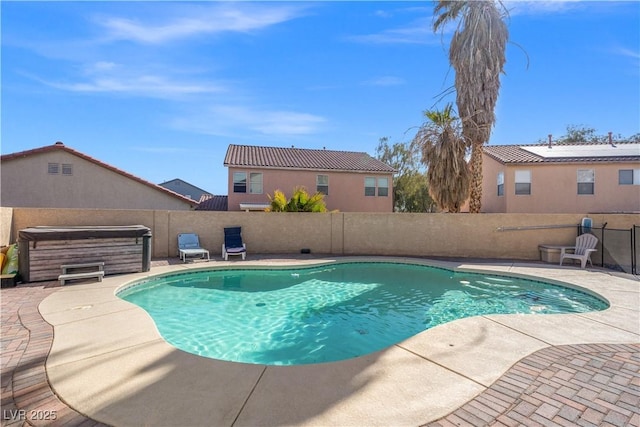 view of swimming pool featuring a fenced in pool, a patio, a fenced backyard, and a hot tub