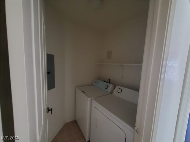 washroom featuring electric panel and washer and clothes dryer