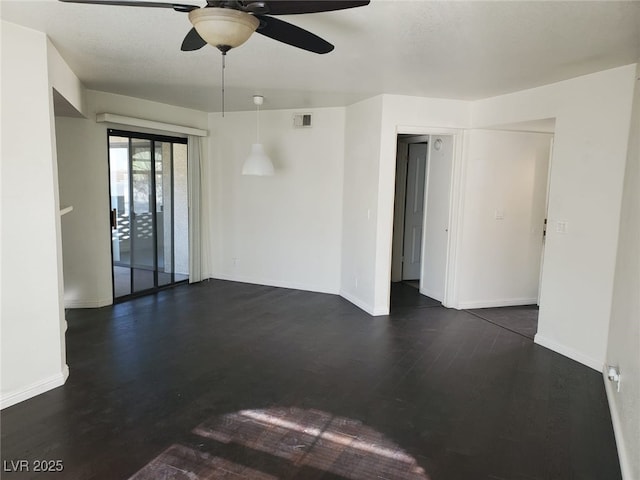 spare room featuring ceiling fan and dark hardwood / wood-style flooring