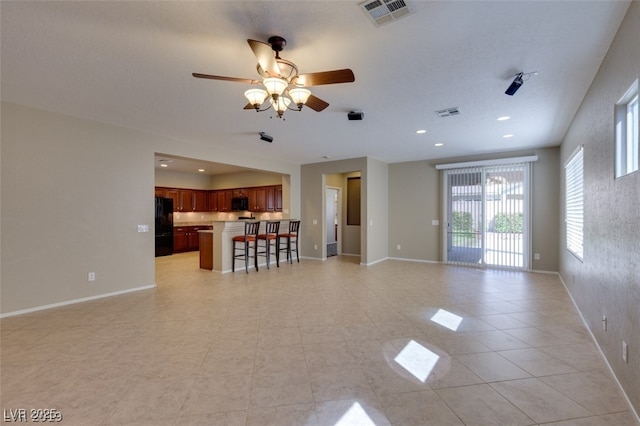 unfurnished living room with light tile patterned floors and ceiling fan