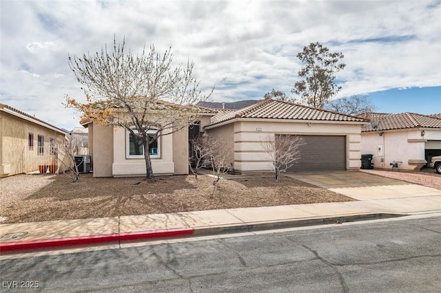 view of front of house featuring a garage and central AC unit