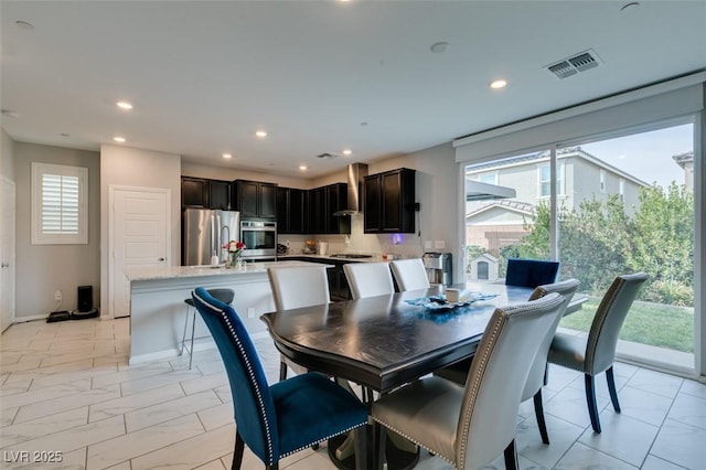 3192 Bormida Ave, Henderson, NV 89044 - dining area with light marble finish flooring, recessed lighting, healthy amount of natural light, and baseboards