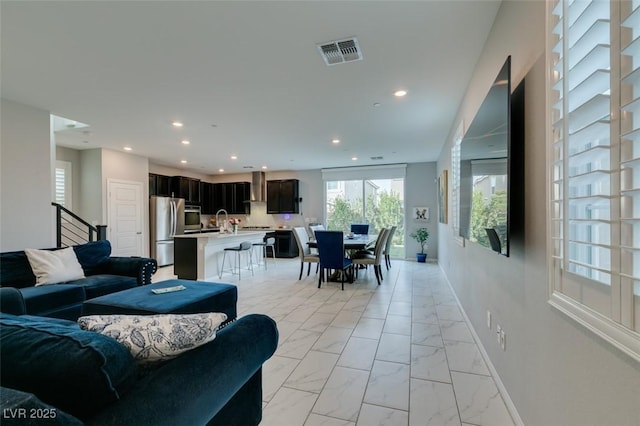 3192 Bormida Ave, Henderson, NV 89044 - living area featuring recessed lighting, light marble finish flooring, stairway, and baseboards