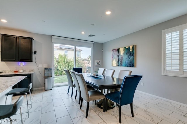 3192 Bormida Ave, Henderson, NV 89044 - dining space with light marble finish flooring, recessed lighting, and baseboards