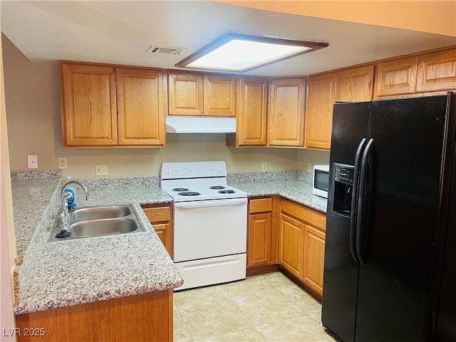 kitchen with brown cabinets, visible vents, a sink, white appliances, and under cabinet range hood