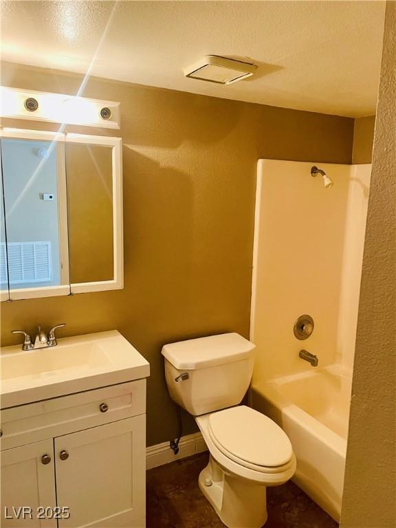 full bath featuring shower / bathtub combination, toilet, a textured ceiling, vanity, and baseboards