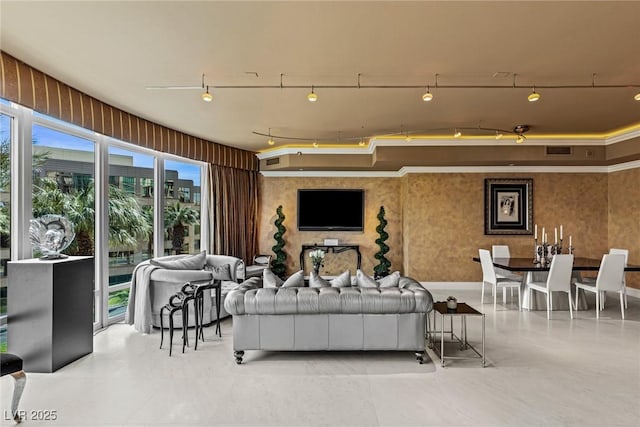 living area featuring track lighting and visible vents