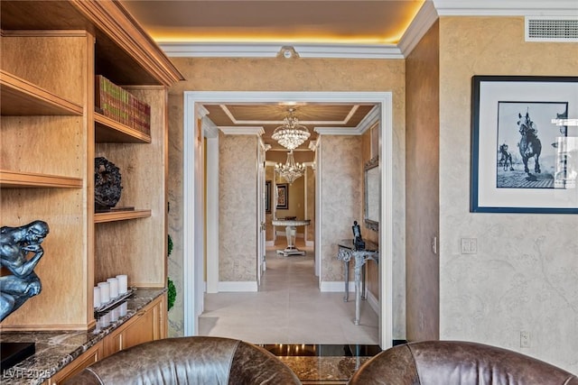 interior space featuring visible vents, baseboards, an inviting chandelier, and crown molding