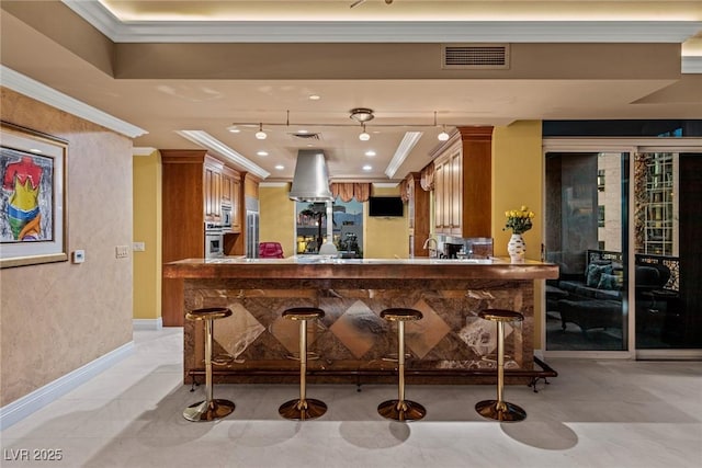 bar featuring visible vents, ornamental molding, recessed lighting, appliances with stainless steel finishes, and baseboards