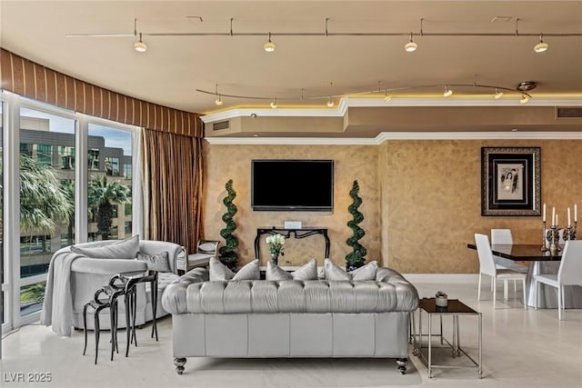 living area with rail lighting, visible vents, concrete flooring, and ornamental molding