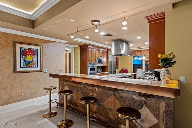 kitchen with visible vents, crown molding, built in appliances, island range hood, and brown cabinetry