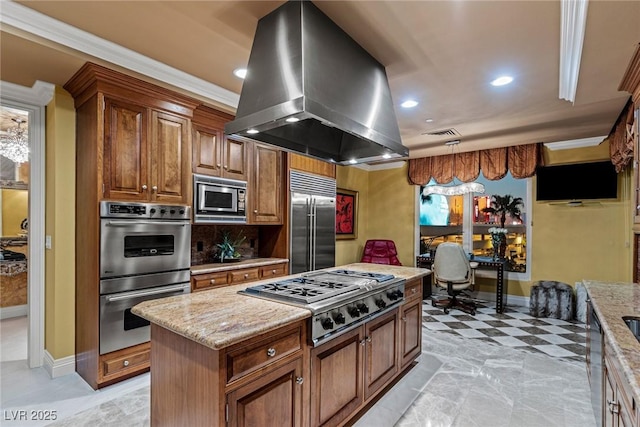 kitchen featuring light stone countertops, brown cabinets, built in appliances, and island range hood