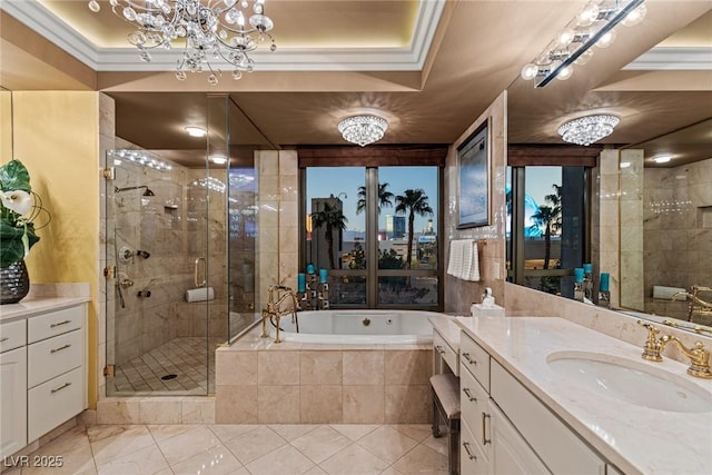 bathroom with a bath, a shower stall, vanity, and an inviting chandelier