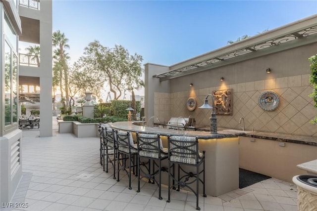 view of patio / terrace featuring area for grilling and outdoor wet bar