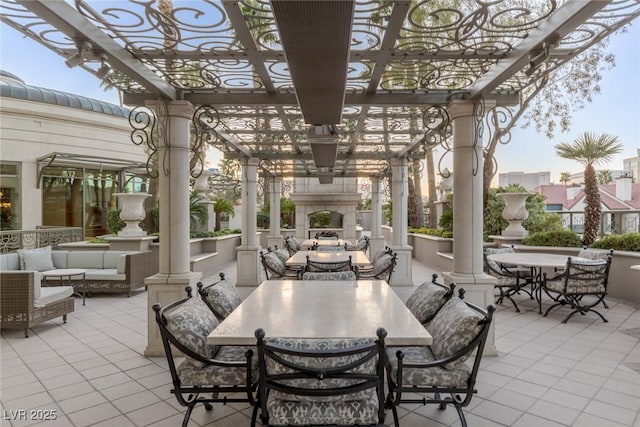 view of patio with an outdoor living space with a fireplace, outdoor dining area, and a pergola