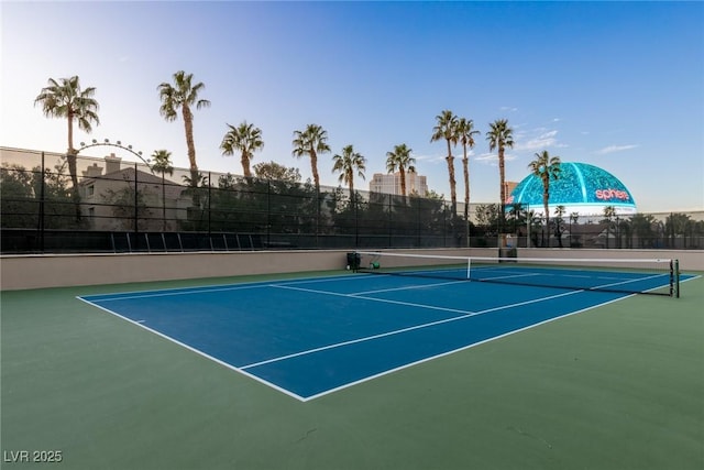 view of sport court featuring fence