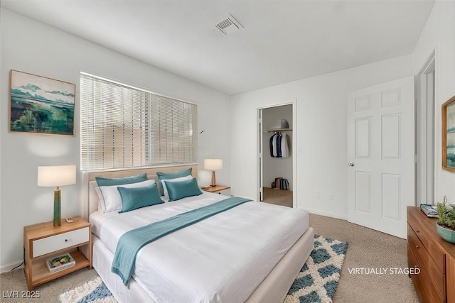 bedroom with carpet, a spacious closet, and a closet