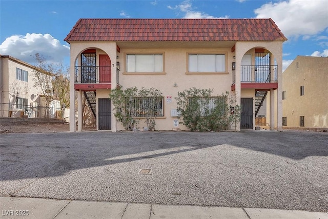 mediterranean / spanish-style house featuring a balcony