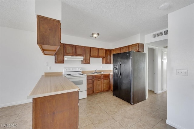 kitchen featuring sink, black refrigerator with ice dispenser, a textured ceiling, light tile patterned floors, and electric range