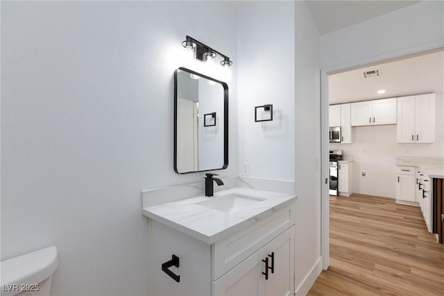 bathroom featuring hardwood / wood-style flooring, sink, and toilet