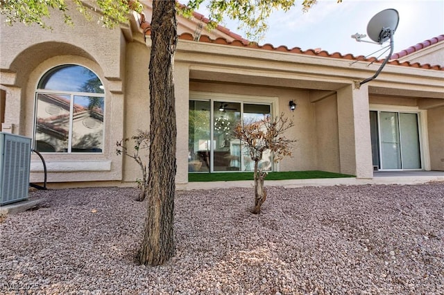 rear view of house featuring central AC unit