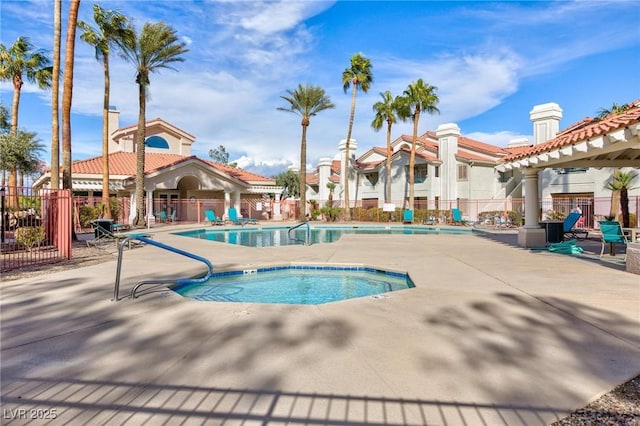 view of pool with a community hot tub, a pergola, and a patio area