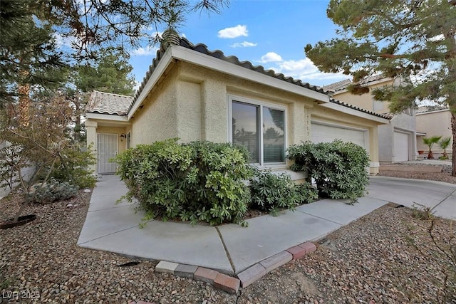 view of side of property with a garage