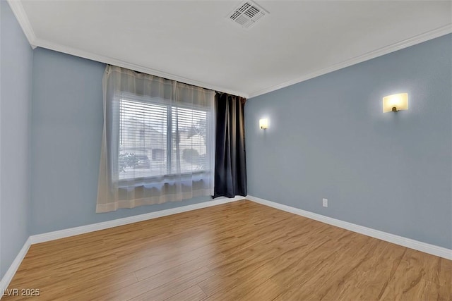 unfurnished room featuring crown molding and light wood-type flooring