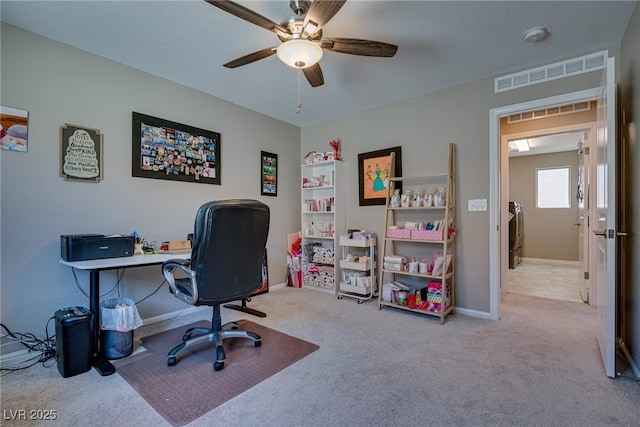 office space with light colored carpet and ceiling fan