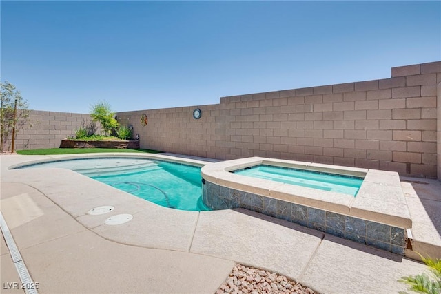 view of swimming pool with an in ground hot tub