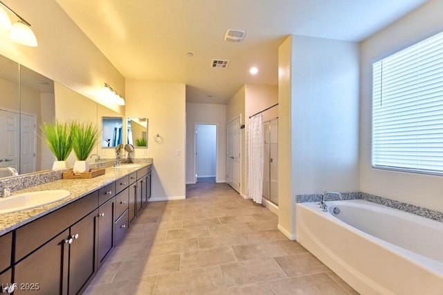 bathroom featuring tile patterned flooring, vanity, plenty of natural light, and independent shower and bath