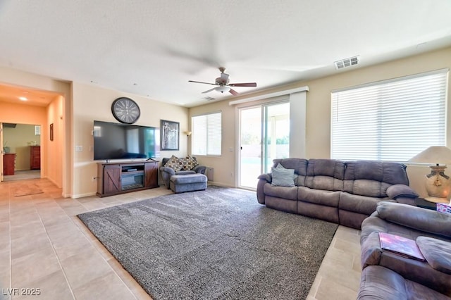 living room featuring ceiling fan and light tile patterned floors