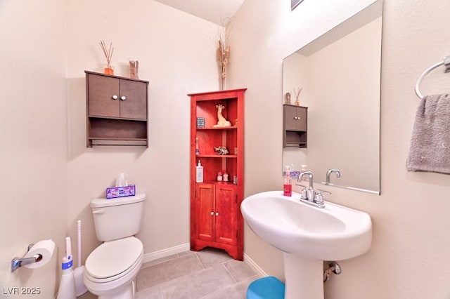 bathroom featuring sink, toilet, and tile patterned floors