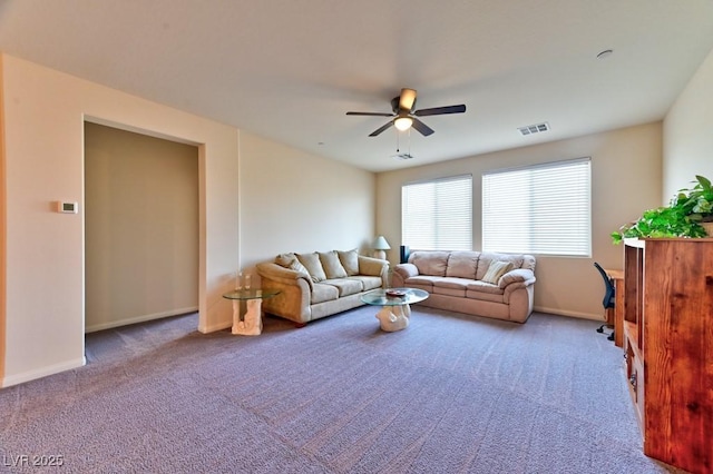 carpeted living room with ceiling fan