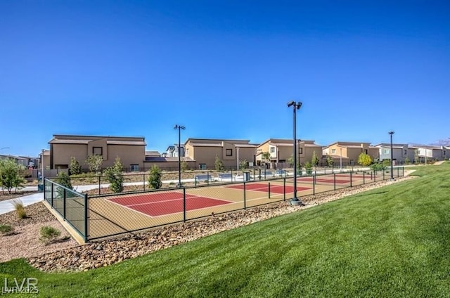 view of sport court with a yard and tennis court