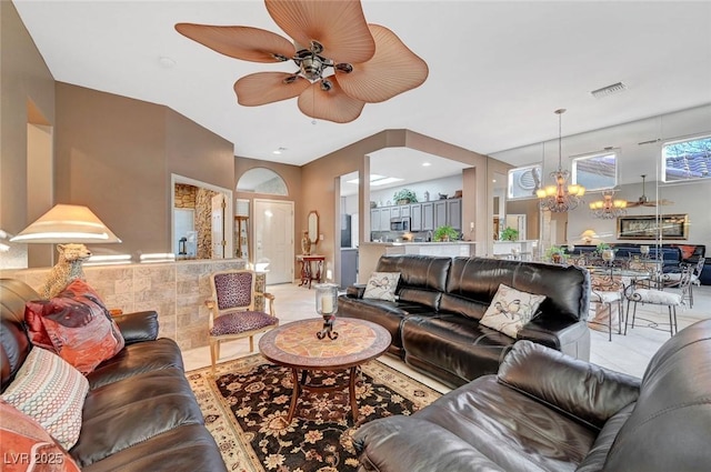 living area with visible vents and ceiling fan with notable chandelier